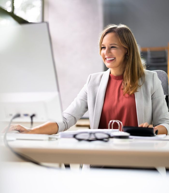 Accountant Women At Desk Using Calculator For Accounting